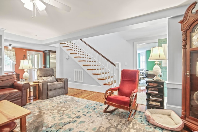 living room featuring hardwood / wood-style floors and ceiling fan