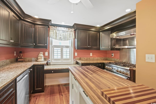 kitchen featuring light hardwood / wood-style floors, wooden counters, stove, stainless steel dishwasher, and dark brown cabinetry