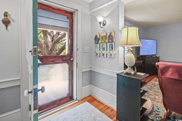 foyer entrance featuring baseboard heating and light hardwood / wood-style flooring