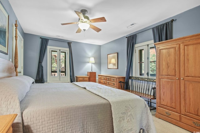 bedroom with light carpet, multiple windows, and ceiling fan