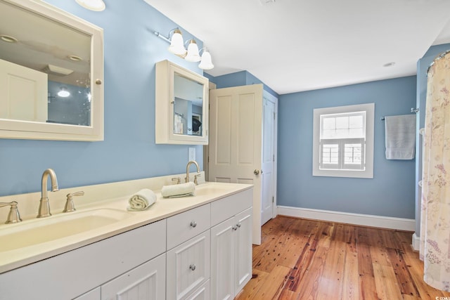 bathroom with vanity and wood-type flooring