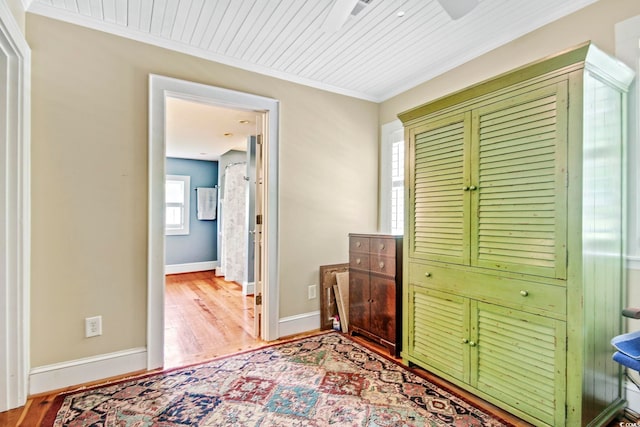 bedroom with hardwood / wood-style flooring, wooden ceiling, and crown molding