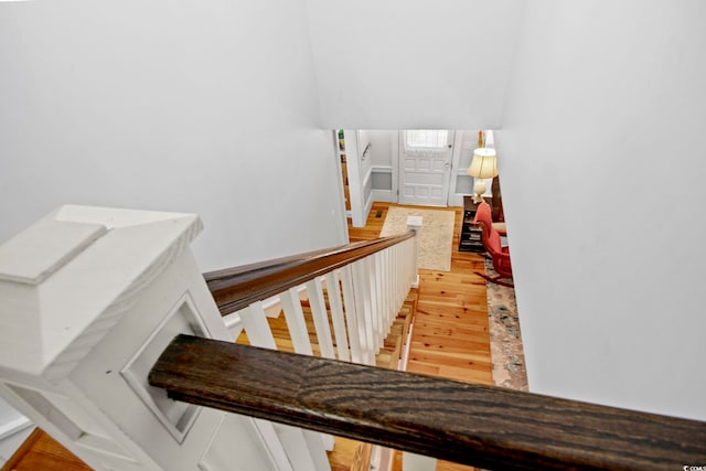 stairway with hardwood / wood-style flooring