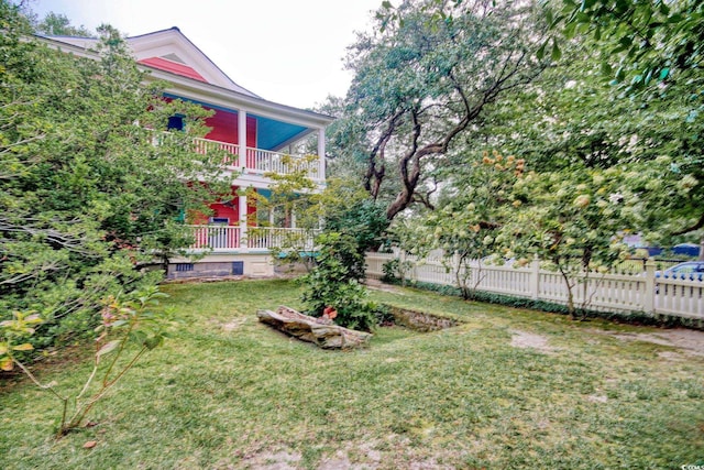 view of yard with a balcony