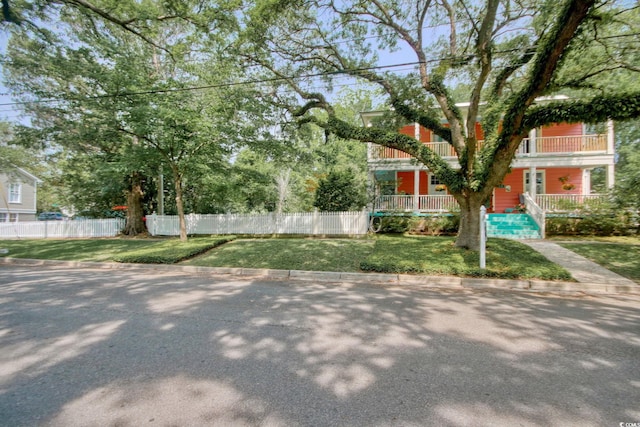 exterior space with covered porch and a balcony