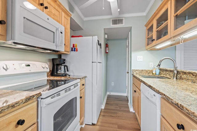 kitchen with white appliances, visible vents, ornamental molding, light brown cabinetry, and a sink