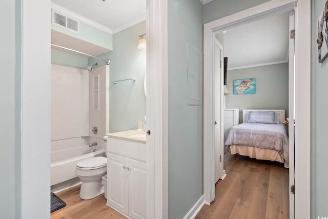 full bath with visible vents, toilet, ornamental molding, vanity, and wood finished floors