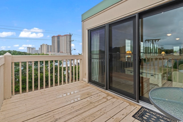 wooden deck with a city view