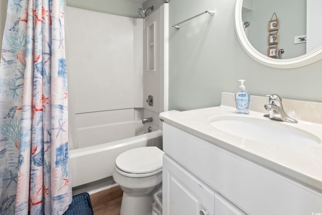 full bathroom with shower / tub combo, vanity, toilet, and wood finished floors