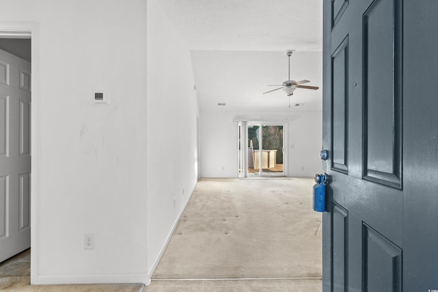 carpeted foyer entrance featuring ceiling fan