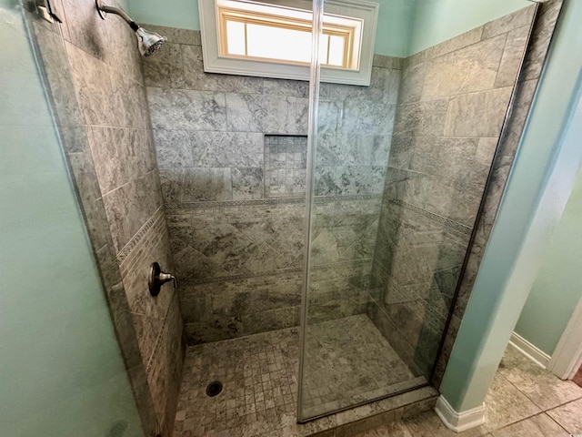 bathroom featuring tile patterned flooring and an enclosed shower