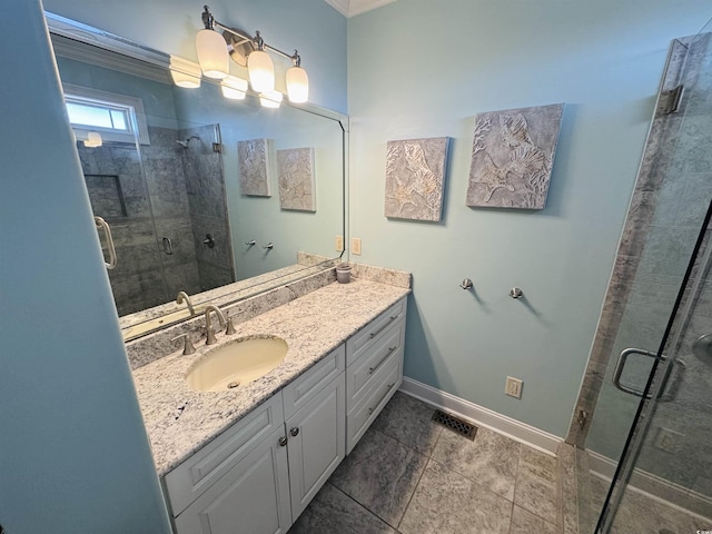 bathroom featuring ornamental molding, a shower with door, and vanity