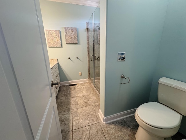 bathroom featuring a shower with door, toilet, and vanity