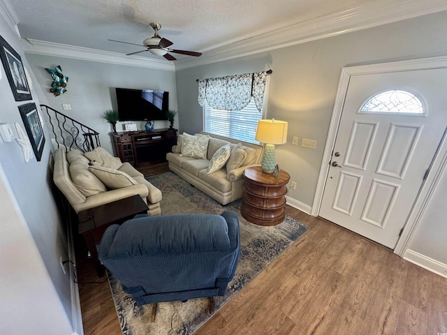 living room featuring crown molding, hardwood / wood-style floors, a textured ceiling, and ceiling fan