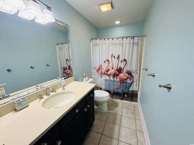 bathroom with tile patterned floors, a textured ceiling, toilet, walk in shower, and vanity