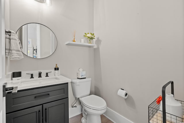 bathroom featuring vanity, toilet, and hardwood / wood-style floors