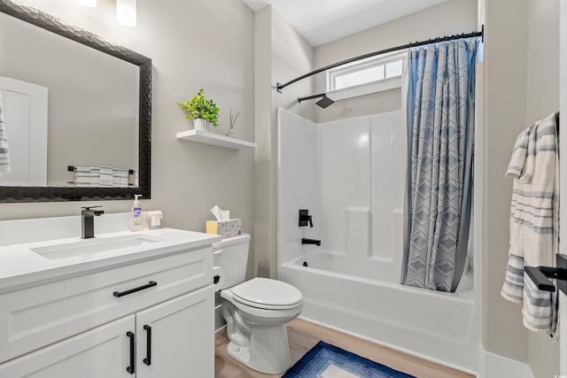 full bathroom featuring shower / bath combo, hardwood / wood-style floors, vanity, and toilet