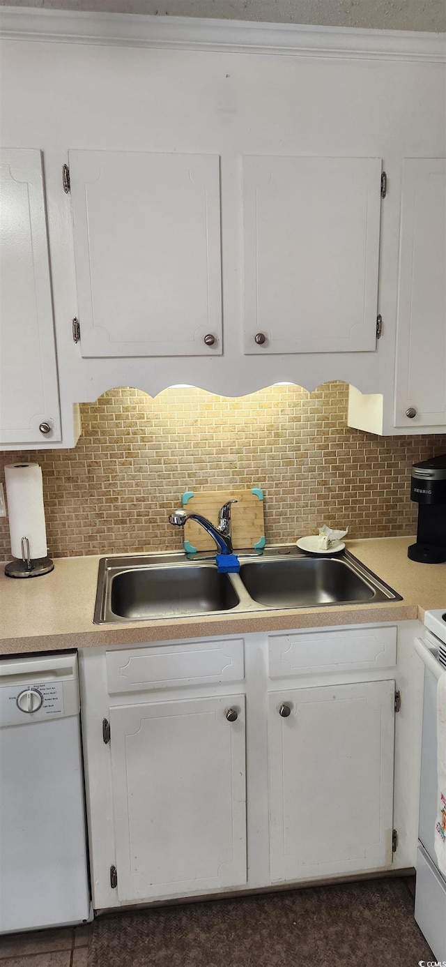 kitchen with sink, white cabinets, backsplash, crown molding, and white appliances