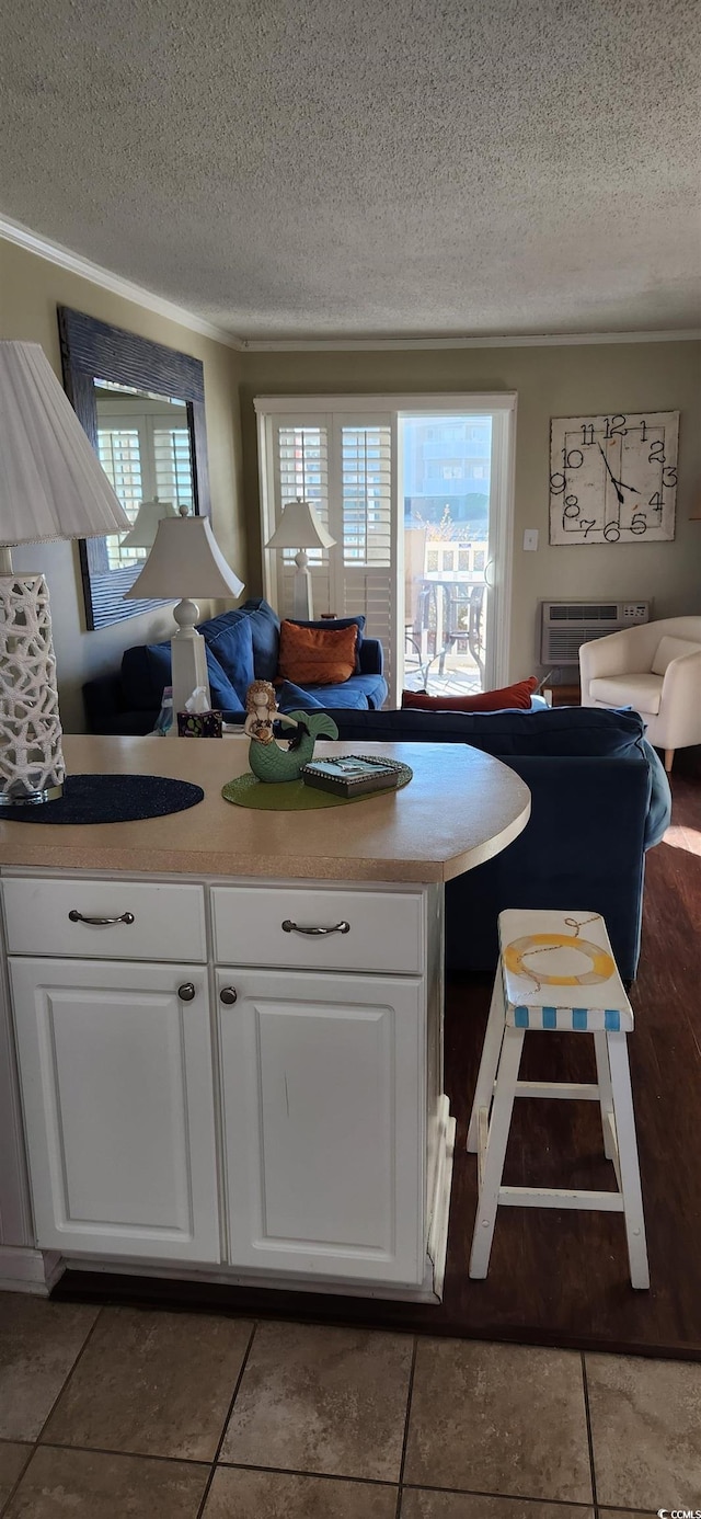 interior space with tile patterned flooring, plenty of natural light, and white cabinets