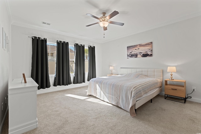 carpeted bedroom featuring ceiling fan and ornamental molding