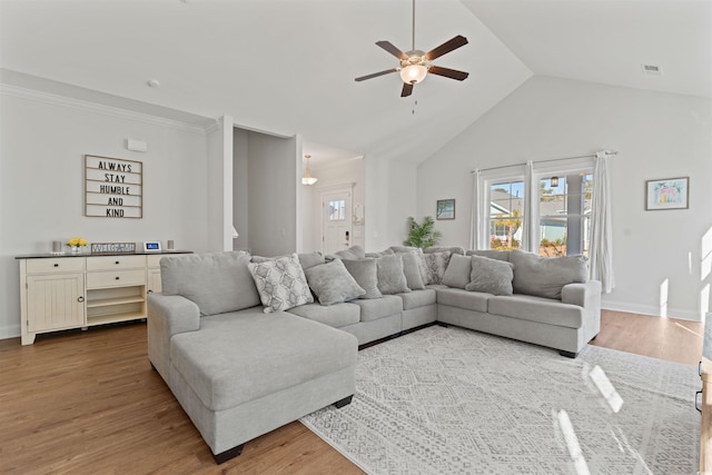 living room featuring hardwood / wood-style flooring, ceiling fan, and lofted ceiling