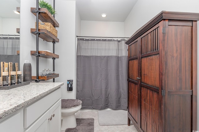 bathroom with toilet, vanity, and a shower with shower curtain