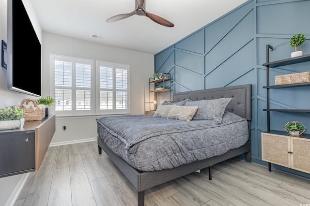 bedroom with light wood-type flooring and ceiling fan