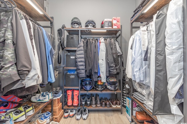 walk in closet with hardwood / wood-style floors