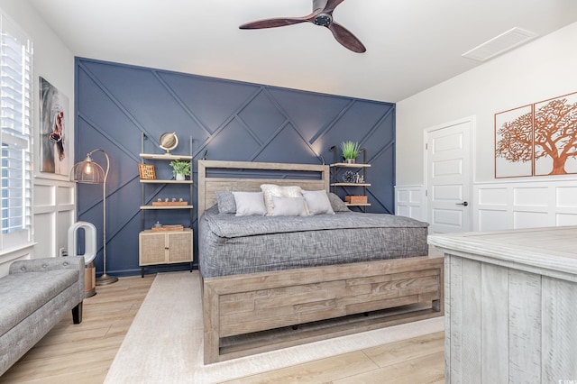 bedroom with a closet, ceiling fan, and light hardwood / wood-style floors