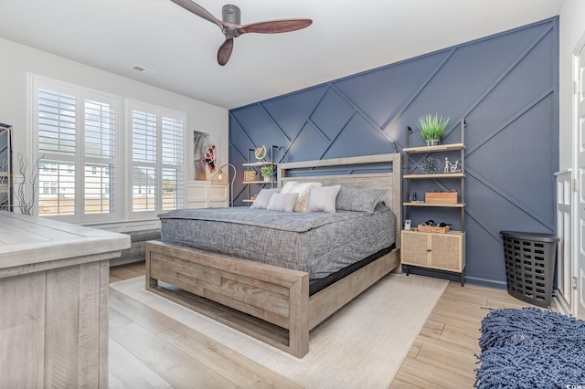 bedroom with ceiling fan and light hardwood / wood-style floors