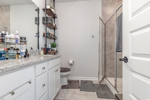 bathroom featuring vanity, walk in shower, tile patterned floors, and toilet