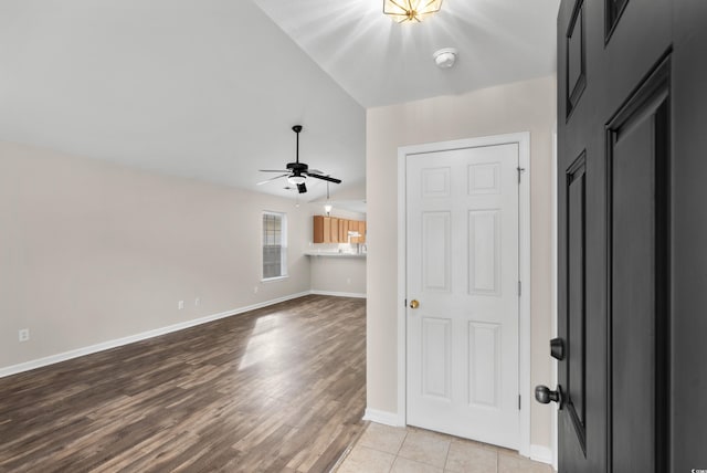 unfurnished room featuring light wood-type flooring, lofted ceiling, and ceiling fan