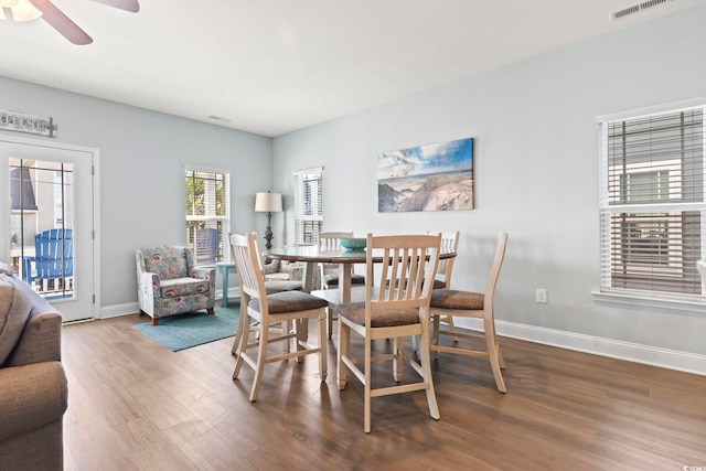 dining room with ceiling fan and hardwood / wood-style floors