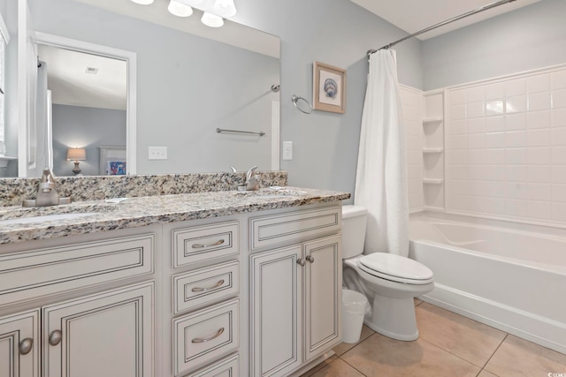 full bathroom with vanity, toilet, shower / bath combo with shower curtain, and tile patterned flooring