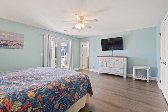 bedroom featuring dark hardwood / wood-style flooring, ceiling fan, and access to outside