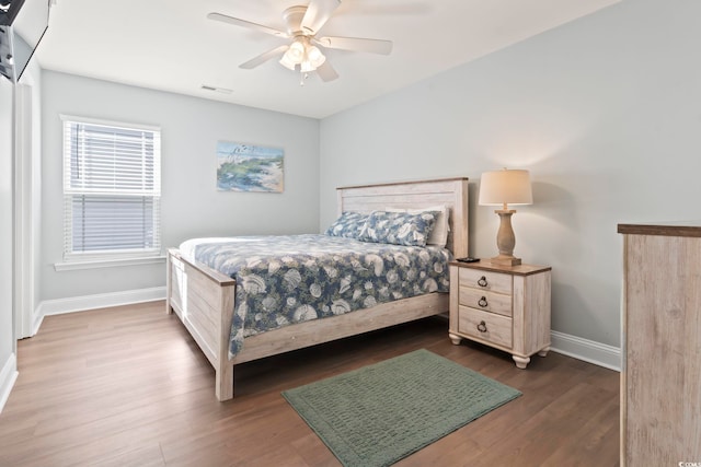 bedroom with ceiling fan and dark hardwood / wood-style flooring