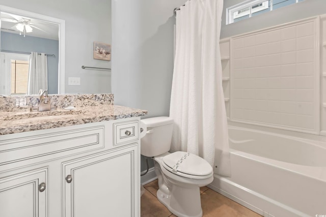 full bathroom featuring tile patterned floors, toilet, vanity, and shower / bath combination with curtain