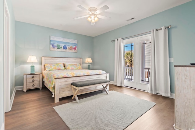 bedroom featuring ceiling fan, dark hardwood / wood-style floors, and access to outside