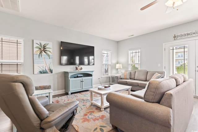 living room with light hardwood / wood-style flooring and ceiling fan