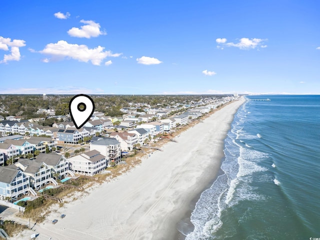 bird's eye view featuring a water view and a view of the beach