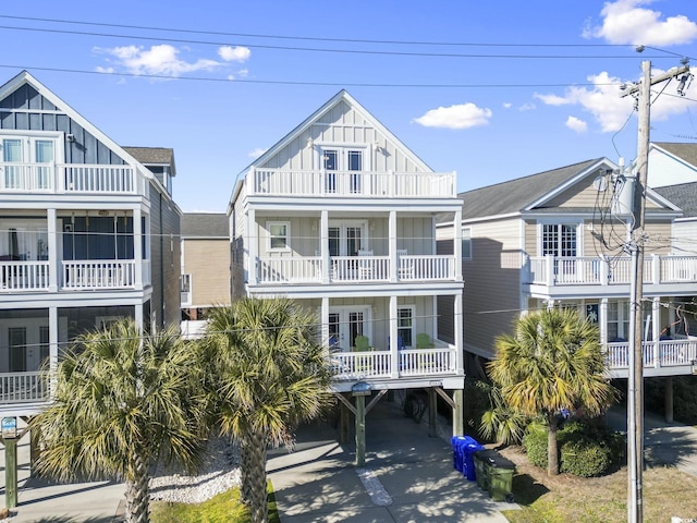 beach home featuring a balcony and a carport