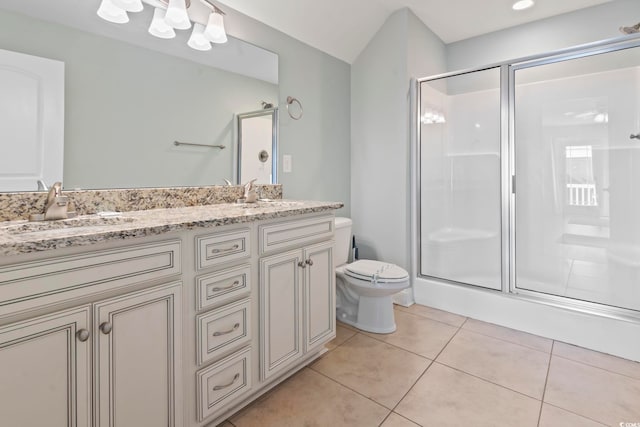 bathroom featuring vanity, toilet, an enclosed shower, and tile patterned flooring