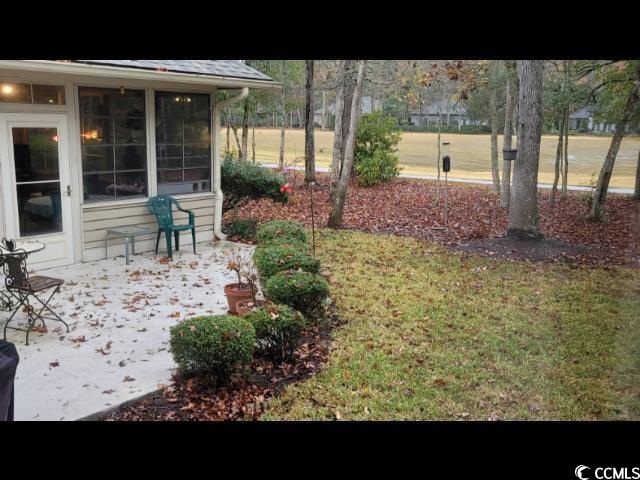 view of yard featuring a sunroom and a patio area