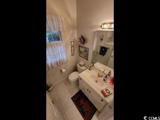 bathroom with vanity, tile patterned floors, and toilet