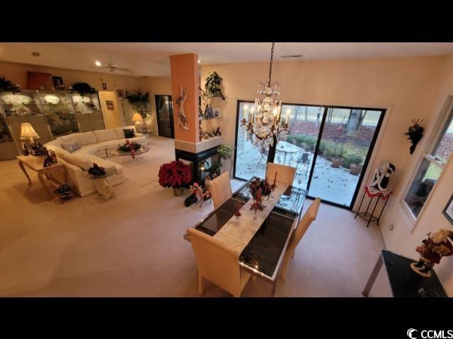 dining area featuring an inviting chandelier and carpet flooring