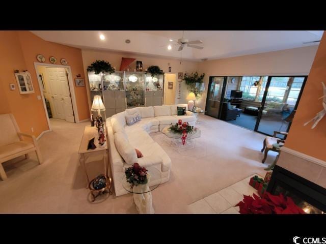 dining area featuring ceiling fan and light carpet