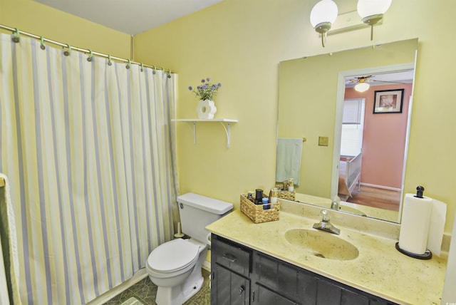 bathroom with toilet, vanity, and walk in shower