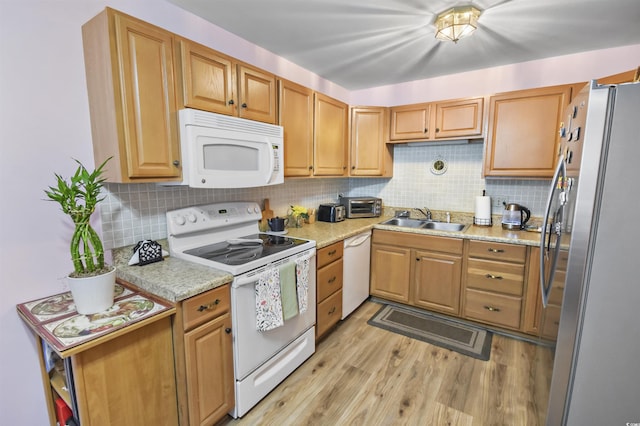 kitchen featuring light hardwood / wood-style flooring, sink, light stone countertops, white appliances, and decorative backsplash