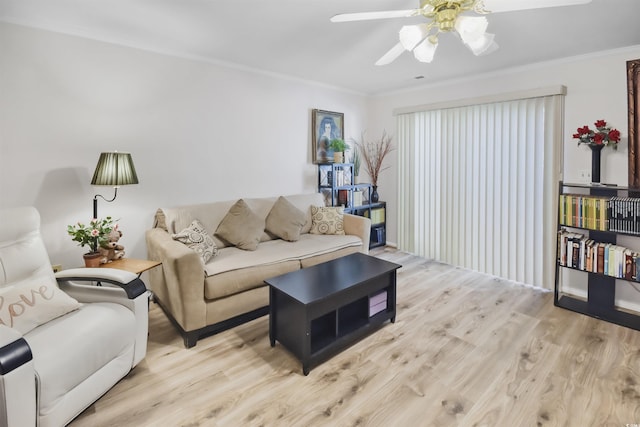 living room featuring ceiling fan, light hardwood / wood-style flooring, and crown molding