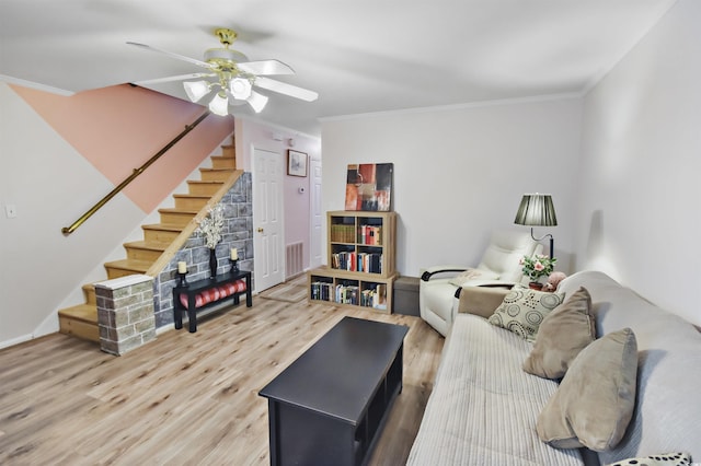 living room with ceiling fan, wood-type flooring, and crown molding